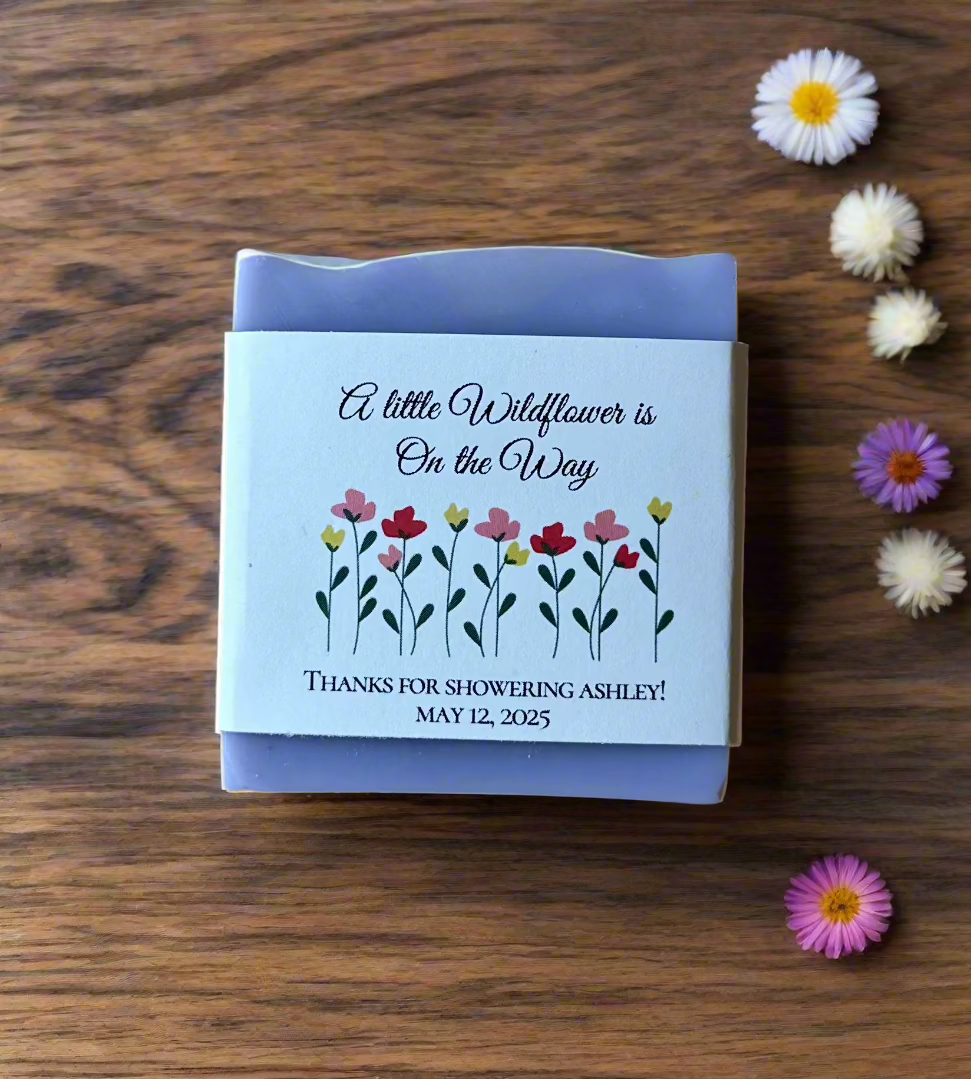 Handmade vegan soap favor with a custom wildflower-themed label, ideal for baby showers. Featuring floral artwork and a personalized message. A natural, eco-friendly, and beautifully packaged gift option