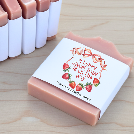 Bar of soap with a strawberry-themed label on a wooden surface
