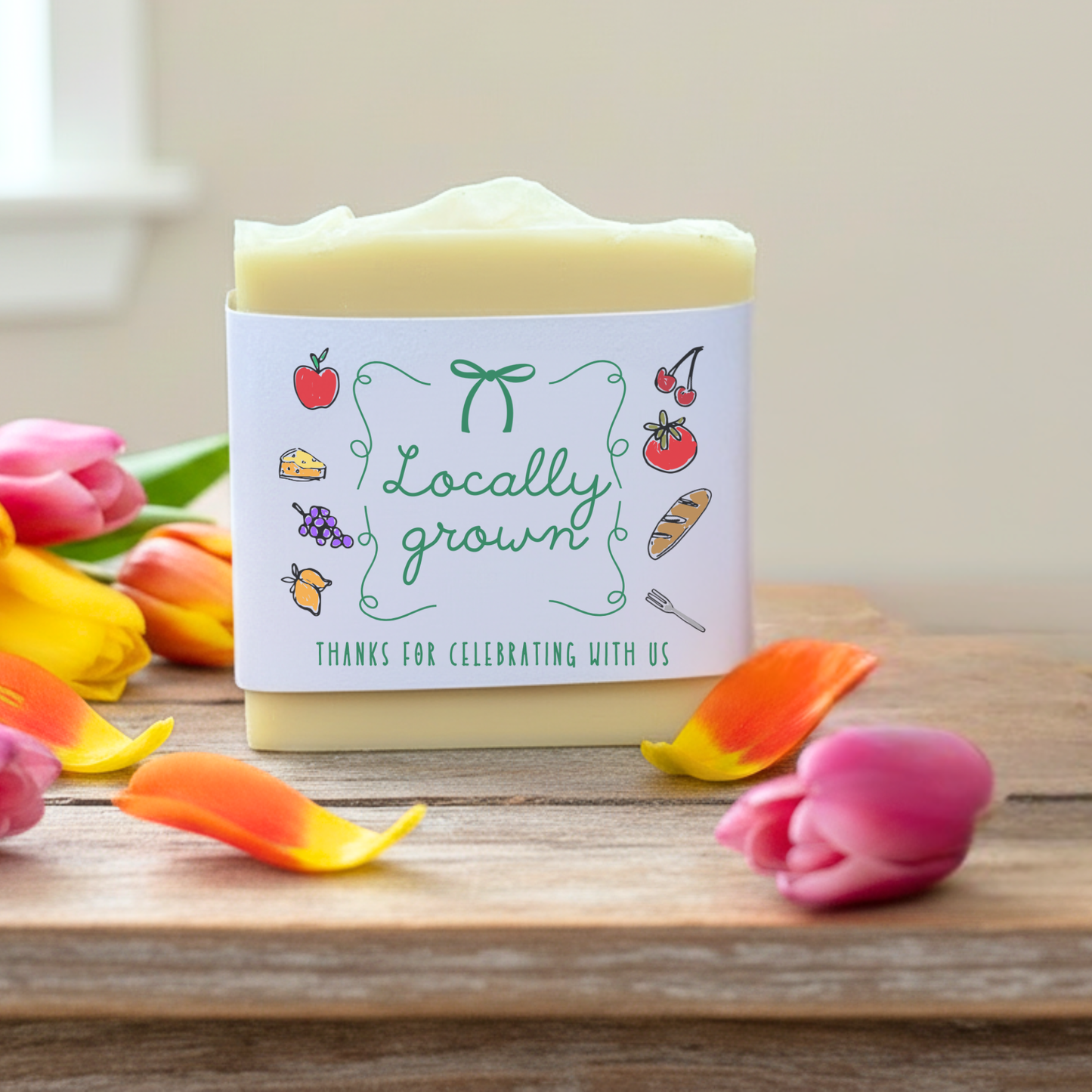 Bar of soap with 'Locally grown' label on a wooden surface with flowers